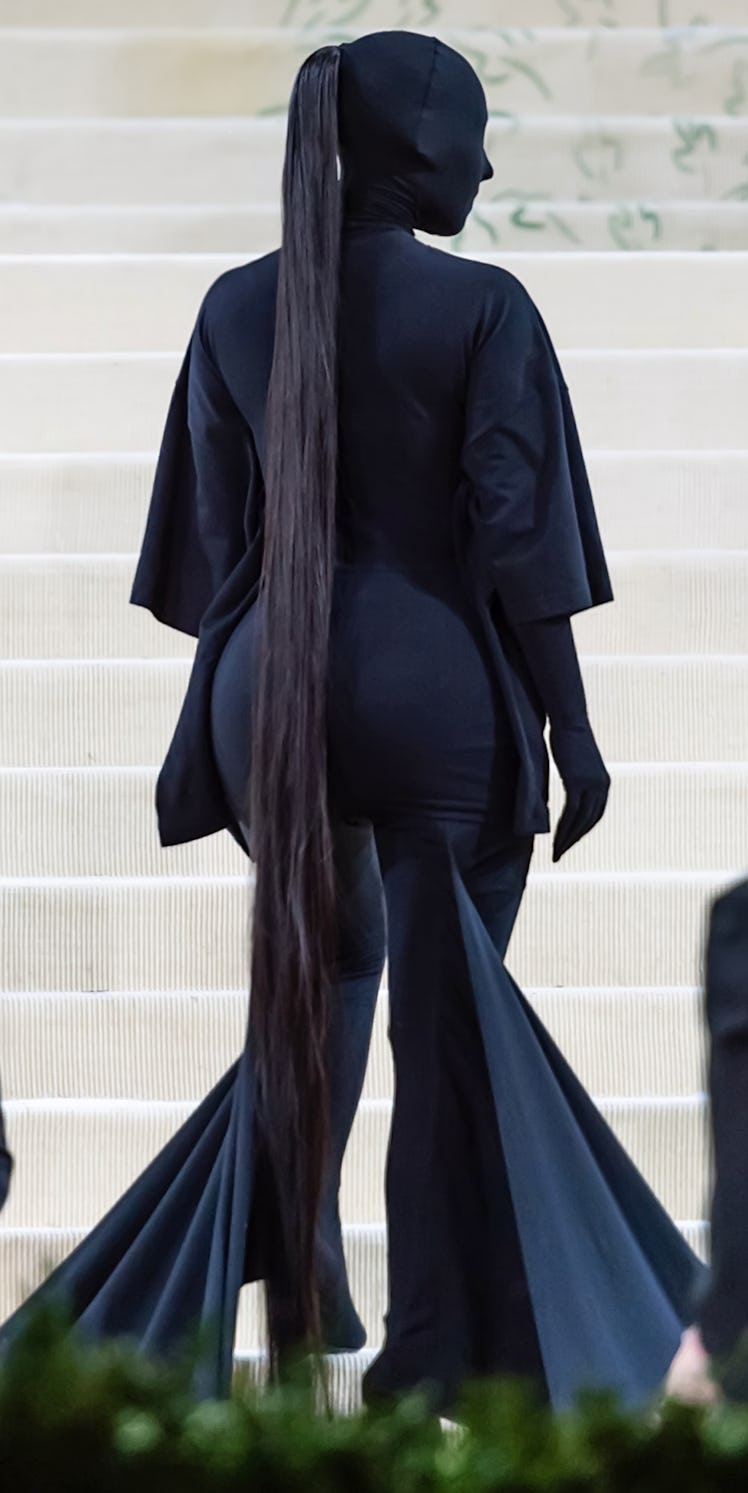 Kim Kardashian completely obscured in black Balenciaga with a long ponytail at the Met Gala
