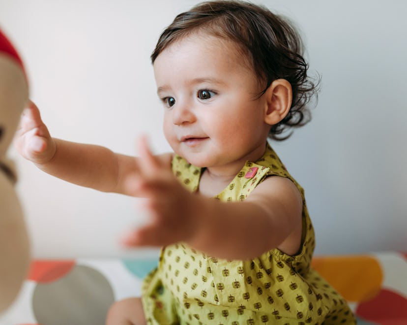 9 month old baby playing with a toy for a 9 month old