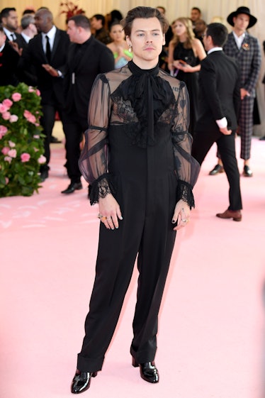 Harry Styles in a sheer Gucci outfit at the Met Gala's pink carpet. 