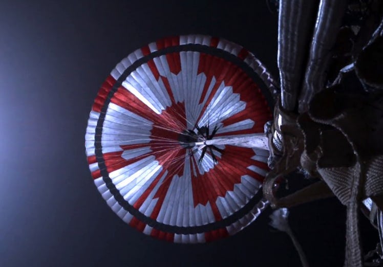 A circle with white and orange stripes represents the underside of a parachute.