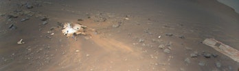 A desert-like scene shows the area on Mars where a rover's landing gear hit the ground.  One round and...