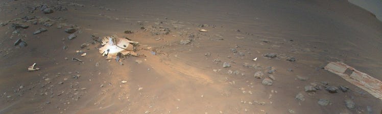A desert-like scene shows the area on Mars where a rover's landing gear hit the ground. A round and ...