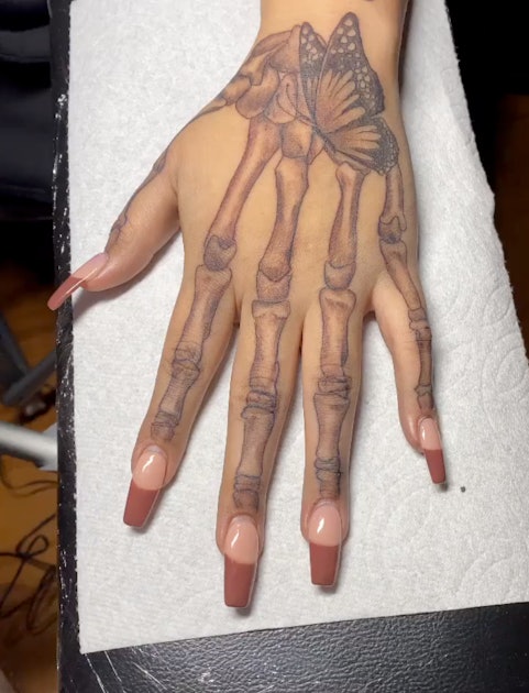 skeleton hand holding tattoo