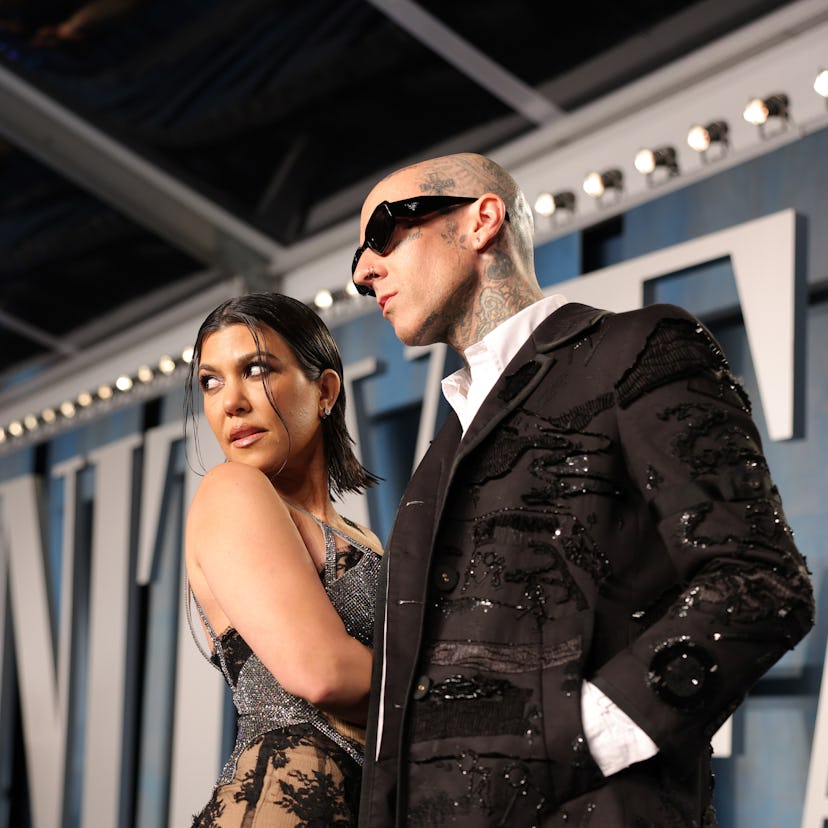 Kourtney Kardashian & Travis Barker at the 2022 Vanity Fair Oscar Party ahead of their 2022 Met Gala...