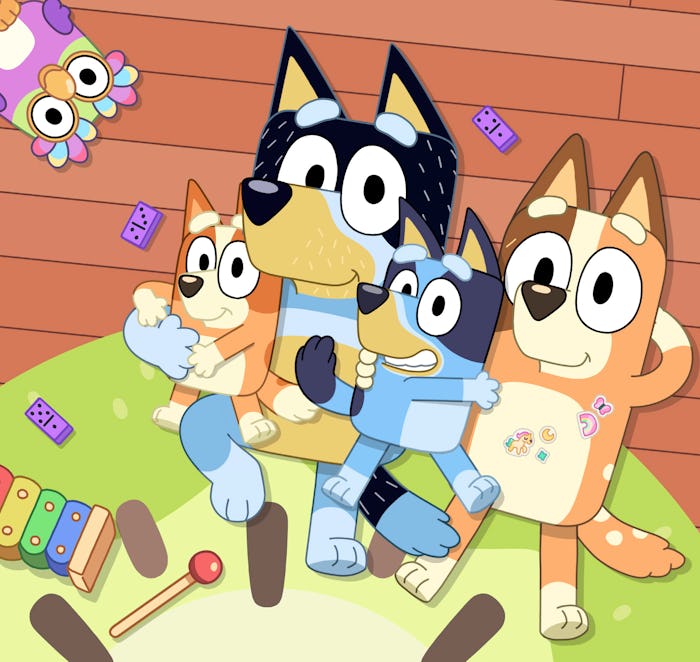 The Heeler family lie on the floor in a cozy bunch in key art for 'Bluey's Big Play'