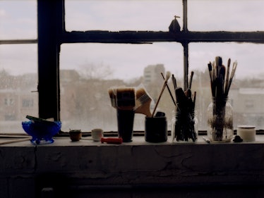 Paintbrushes and other items sitting on windowsill of Kylie's studio