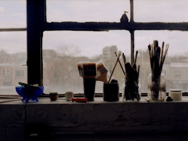 Paintbrushes and other items sitting on windowsill of Kylie's studio