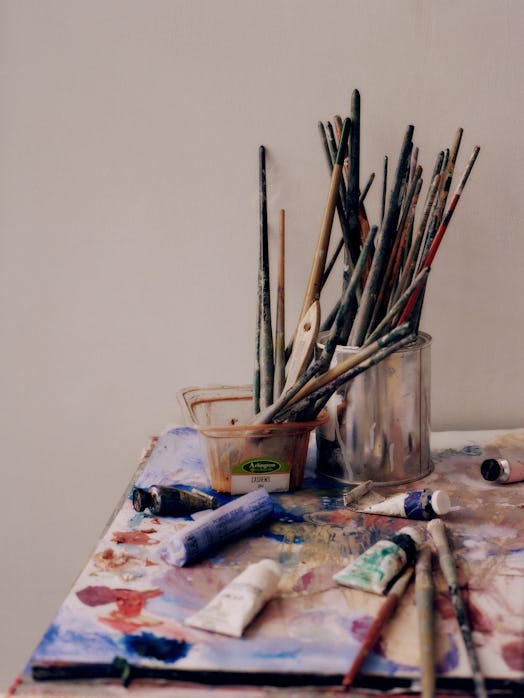 Paintbrushes and paints in Kylie's studio
