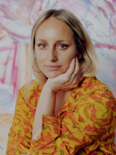 A portrait of Kylie Manning in a yellow and orange shirt