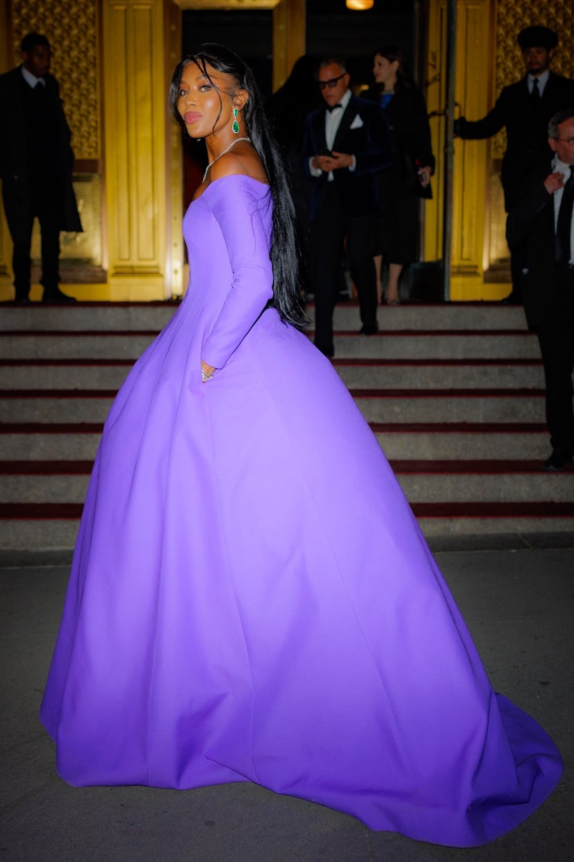 Naomi Campbell wearing a voluminous purple Valentino gown