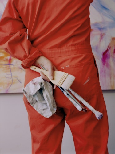 Kylie holding paintbrushes
