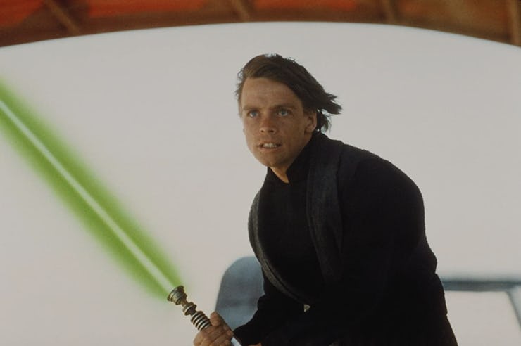 Mark Hamill as Luke in Star Wars holding a light saber