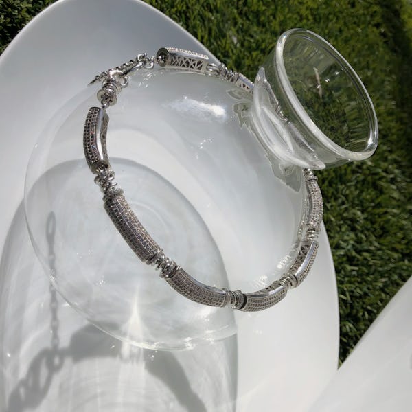 a silver necklace by Mounser