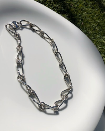 a silver chain-link necklace by Mounser