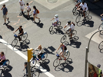 People on the street walking and riding bikes to combat climate change