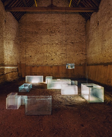 a barn filled with cuboid sculptures made from glass