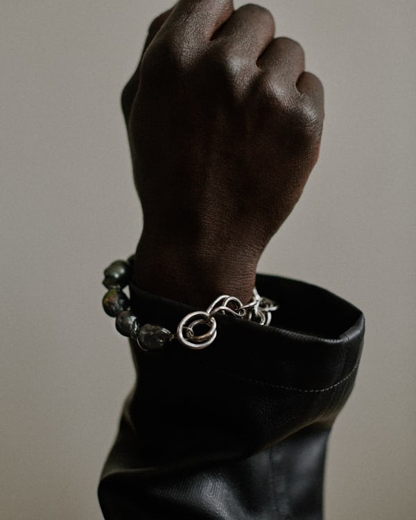 a silver chain-link bracelet by Completedworks
