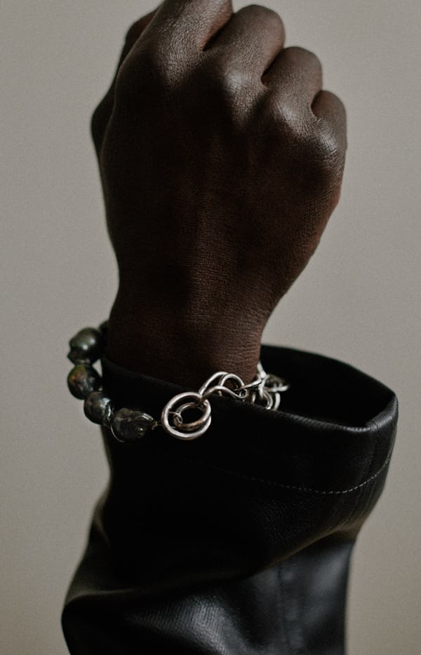 a silver chain-link bracelet by Completedworks