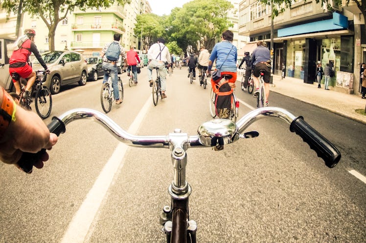The point of view from a person on a bike with other people riding bikes in front of them 