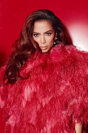 Anitta, the Brazillian pop star posing in a red feather Fendi coat and Ben-Amun earring