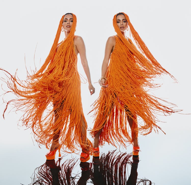 Anitta, Brazillian pop star showing two sides of the same orange outfit, orange dress full of tassel...