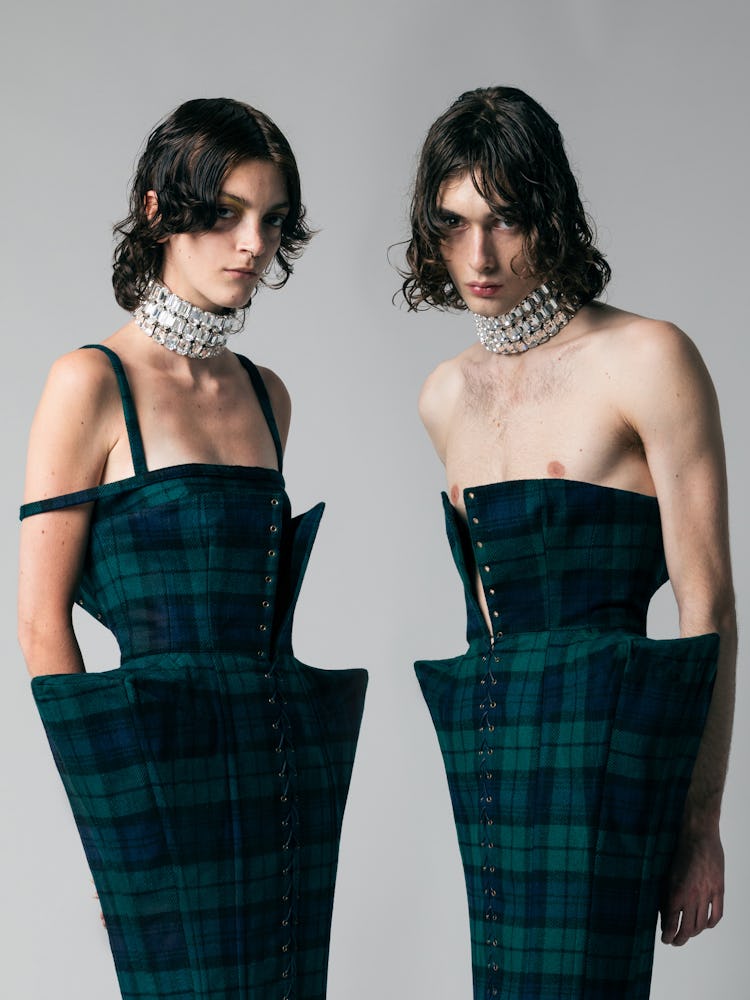 two models wearing tartan corset dresses