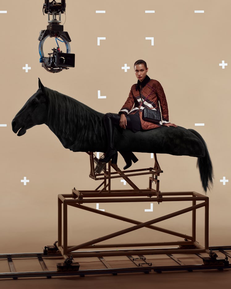 Bella Hadid atop a fake horse in a Burberry campaign