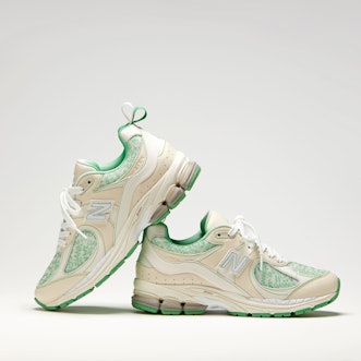 Ganni And New Balance collaboration On A Y2K Sneaker in green and beige from the side one on top of ...