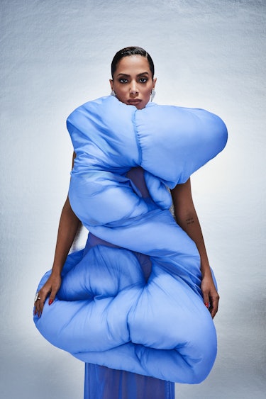 Anitta, the Brazillian pop star in a blue outfit that resembles a bed cover made by Melitta Baumeist...