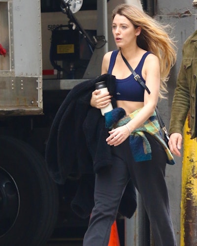 Blake Lively wears a navy sports bra from Alo Yoga.