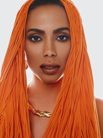 Cloce up of Anitta wearing an orange Vaquera dress and headpiece, Dorsey, Joanna Laura Constantine a...