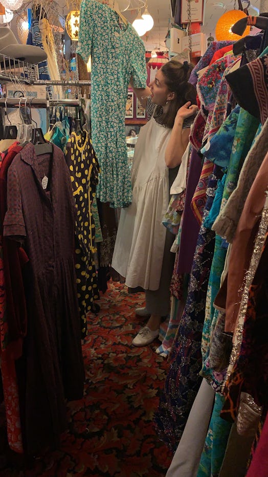 A woman shopping for vintage clothing. 
