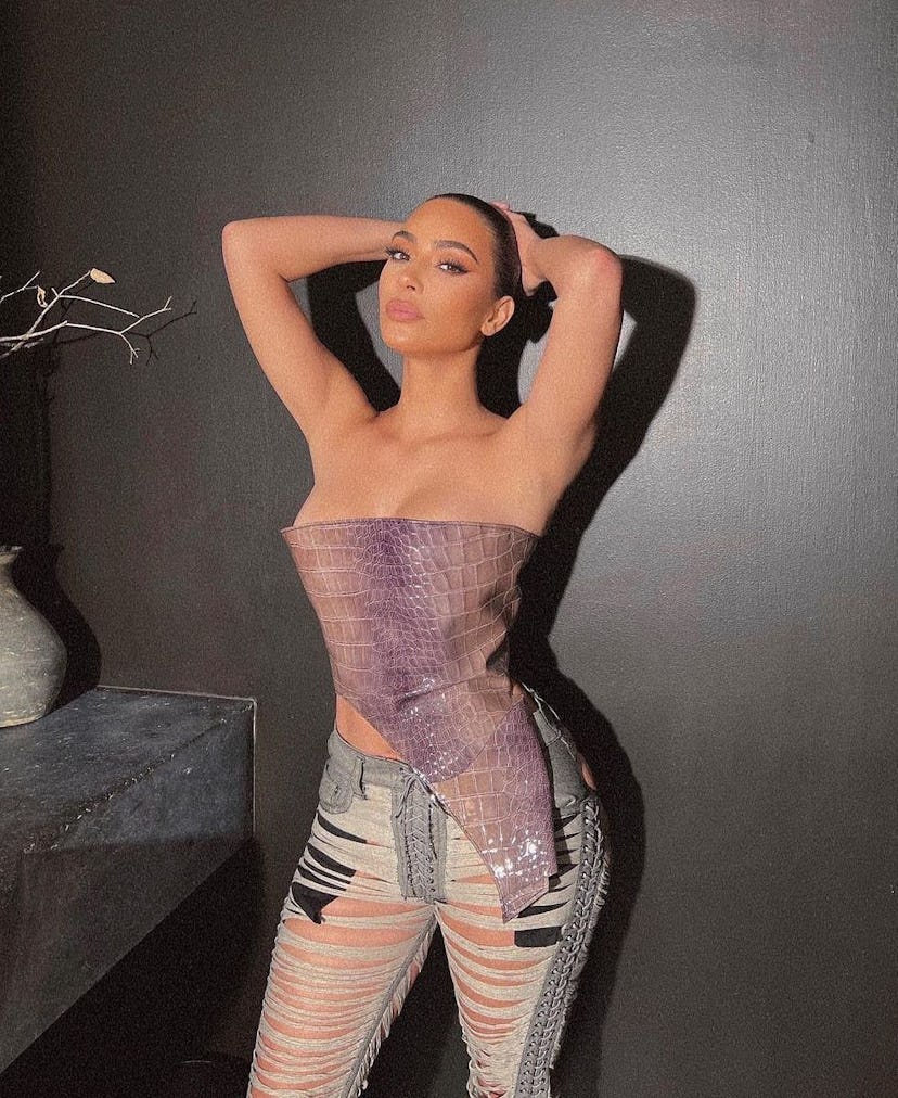 Kim Kardashian wearing a corset and ultra shredded jeans