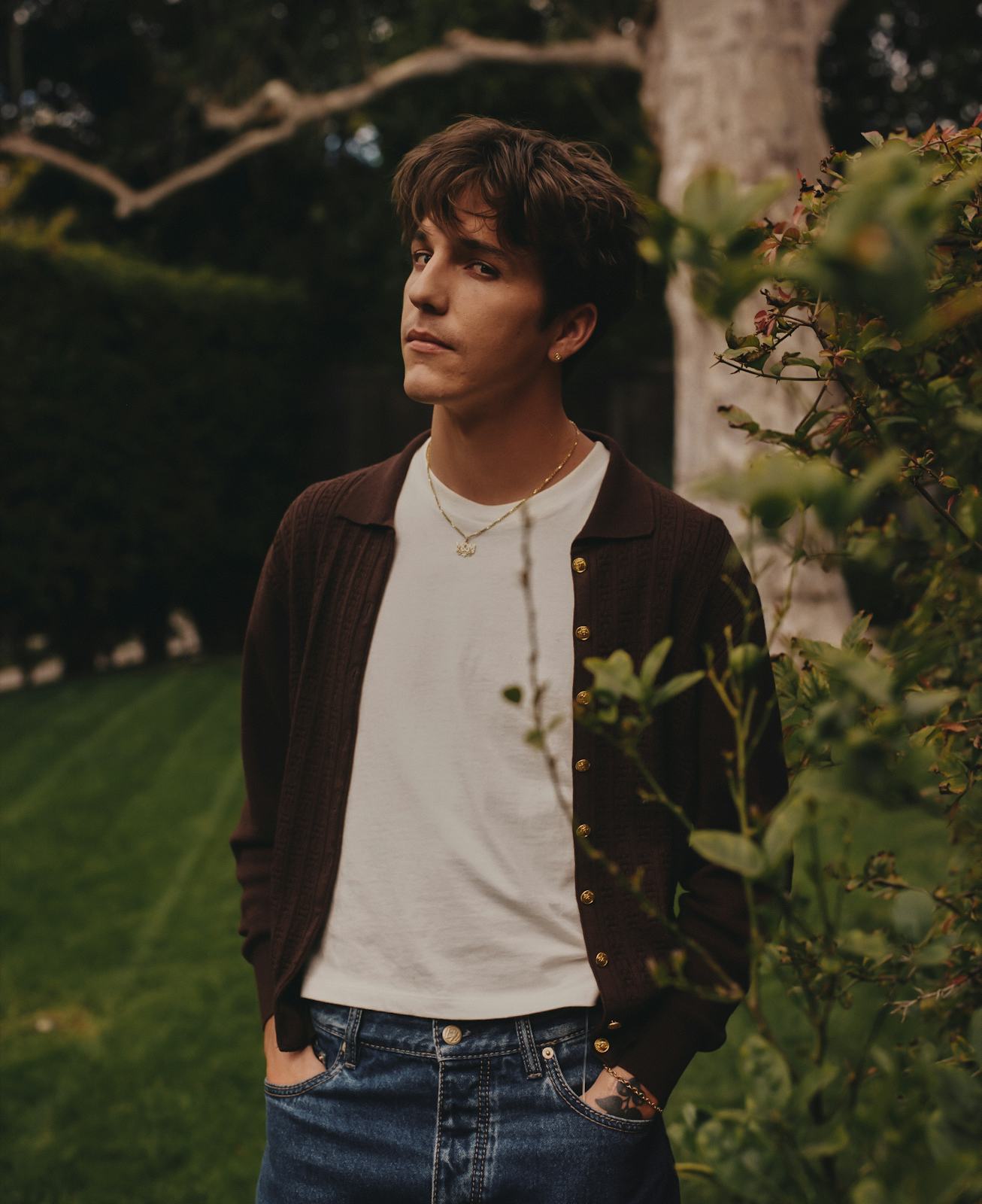 Artist Role Model known for his debut album "RX" standing in the woods