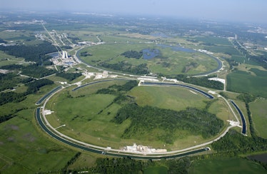 open pasture at fermilab with pipes on top in a loop representing the tevatron