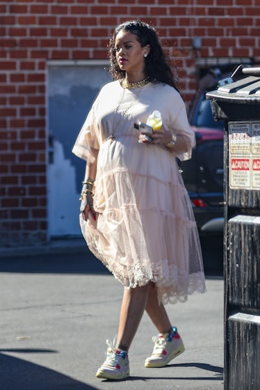 A pregnant Rihanna wearing a pale pink dress by Simone Rocha