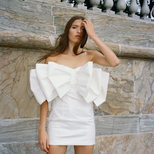 A mini dress with oversize bow from ROTATE WEDDING Spring 2023 collection.