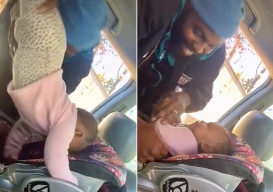 A dad has gone viral for keeping his cool while putting his baby in her car seat.
