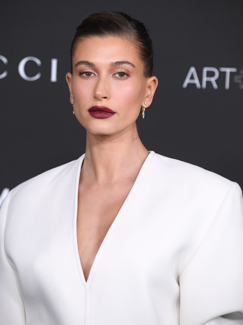 Hailey Bieber at a Gucci red carpet wearing a dark lip look