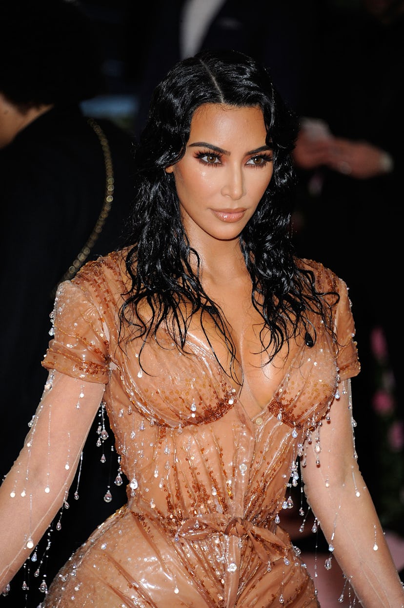 Kim Kardashian West at the Met Gala in a nude, skin-tight dress with jewels looking like rain drops