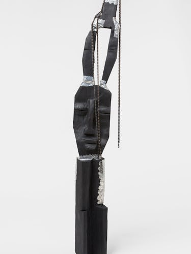 A sculpture of a skinny face by Leilah Babirye