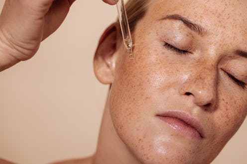 woman applying encapsulated retinol serum