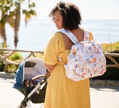 mother pushing stroller with jujube and stitch diaper bag backpack