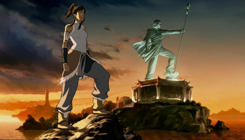 Korra stands in front of a statue of her predecessor, Avatar Aang.