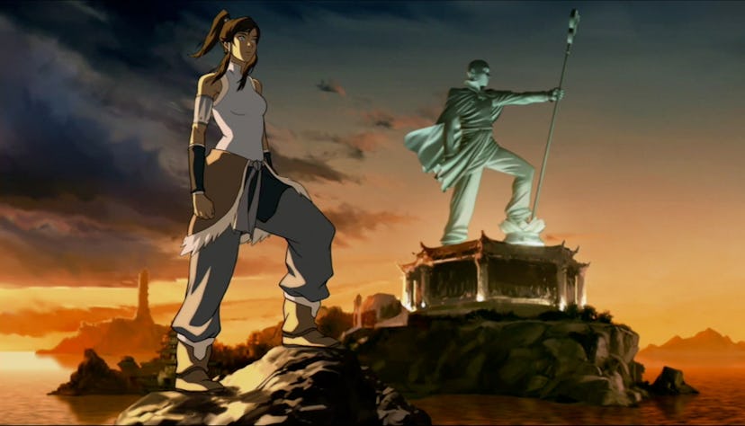 Korra stands in front of a statue of her predecessor, Avatar Aang.