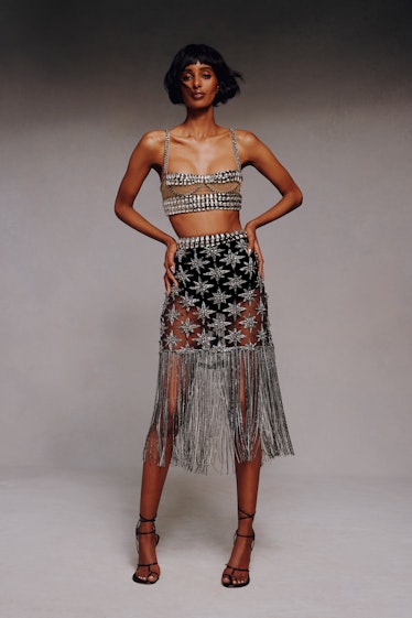Model on the NY Fashion Week Fall 2022 in an Aliétte silver detailed skirt and crop top