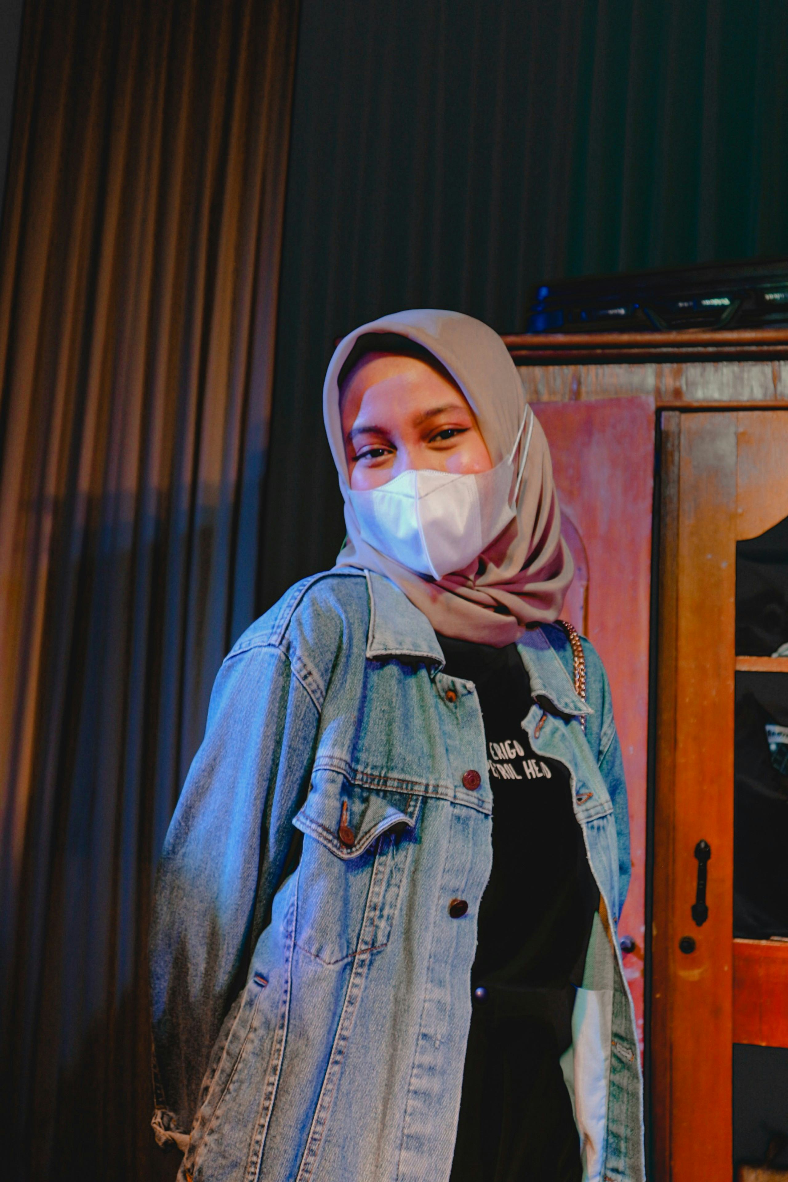 Young woman wearing a mask on Friday the 13th 2022 before reading her zodiac sign's horoscope.