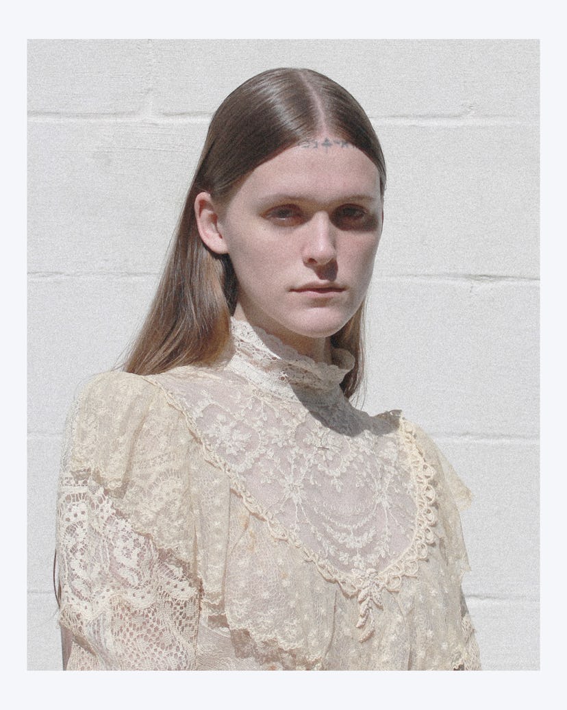 Ethel Cain in a white lace top with long sleeves and turtleneck-resembling collar