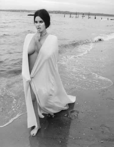 Lana del Rey walking down the beach in Valentino gown wearing a Swarovski necklace.