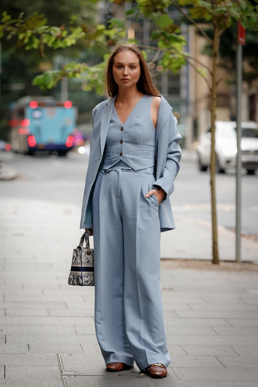 A guest wearing blue Henne suit and Christian Dior bag 